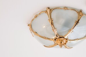 A gold-framed, ornate ceiling light fixture.