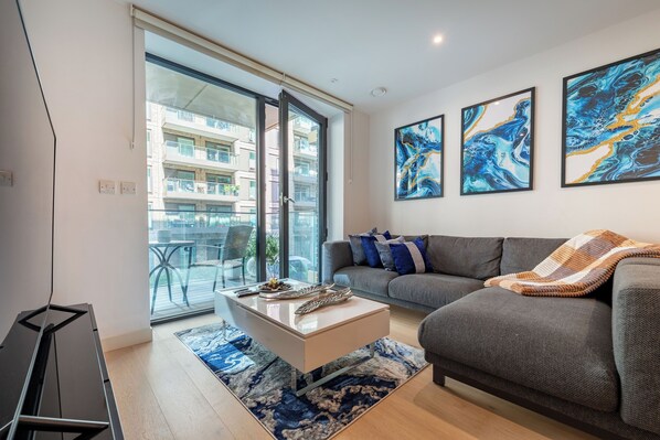 A modern living room with a sofa, a coffee table, and abstract art on the wall.