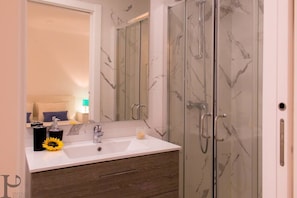 Shower, hair dryer, towels, toilet paper
