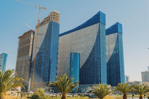 A modern skyscraper with a unique architectural design, featuring multiple curved and angular sections.