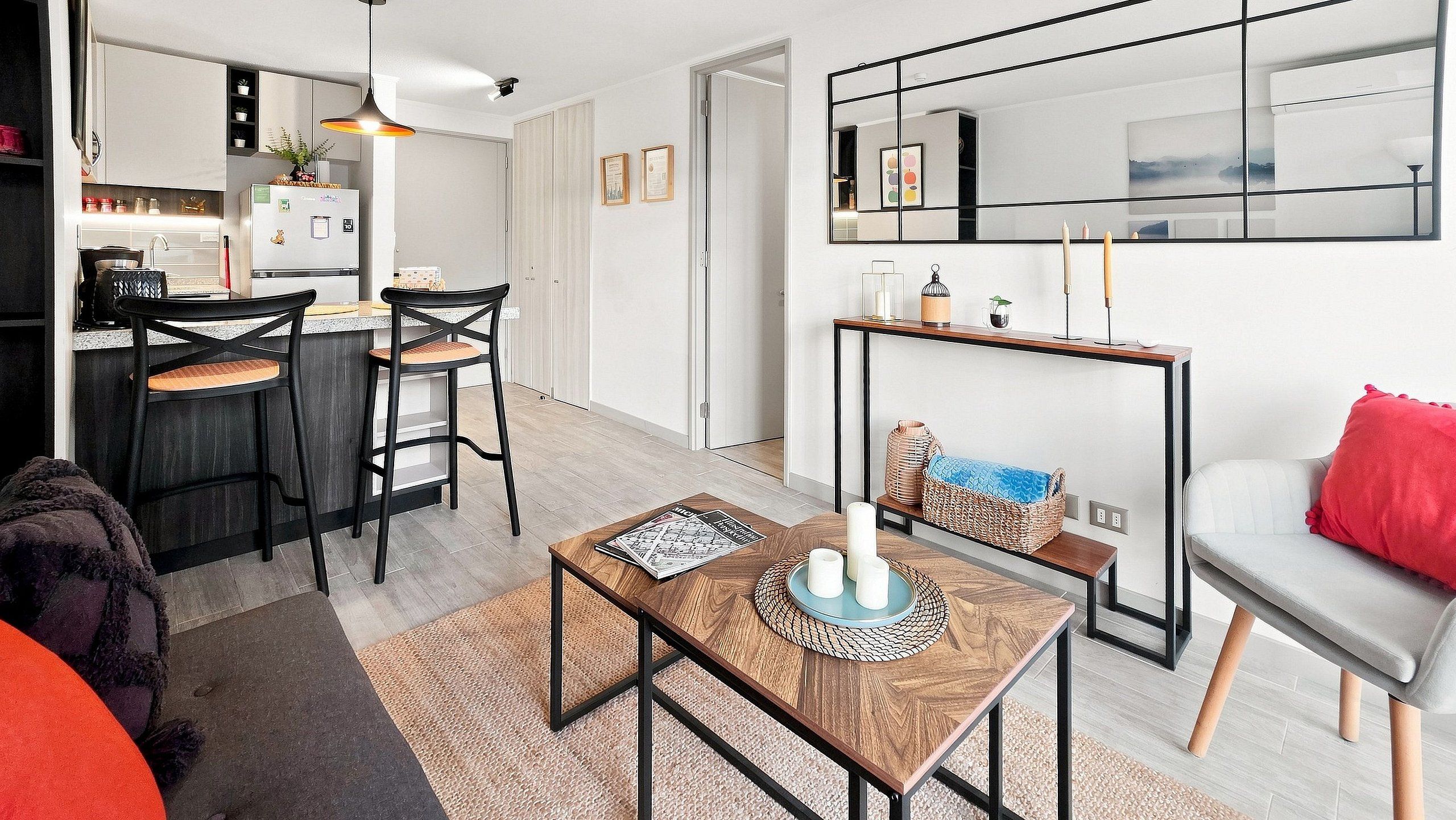 A modern living space with a kitchen, dining area, and seating area.