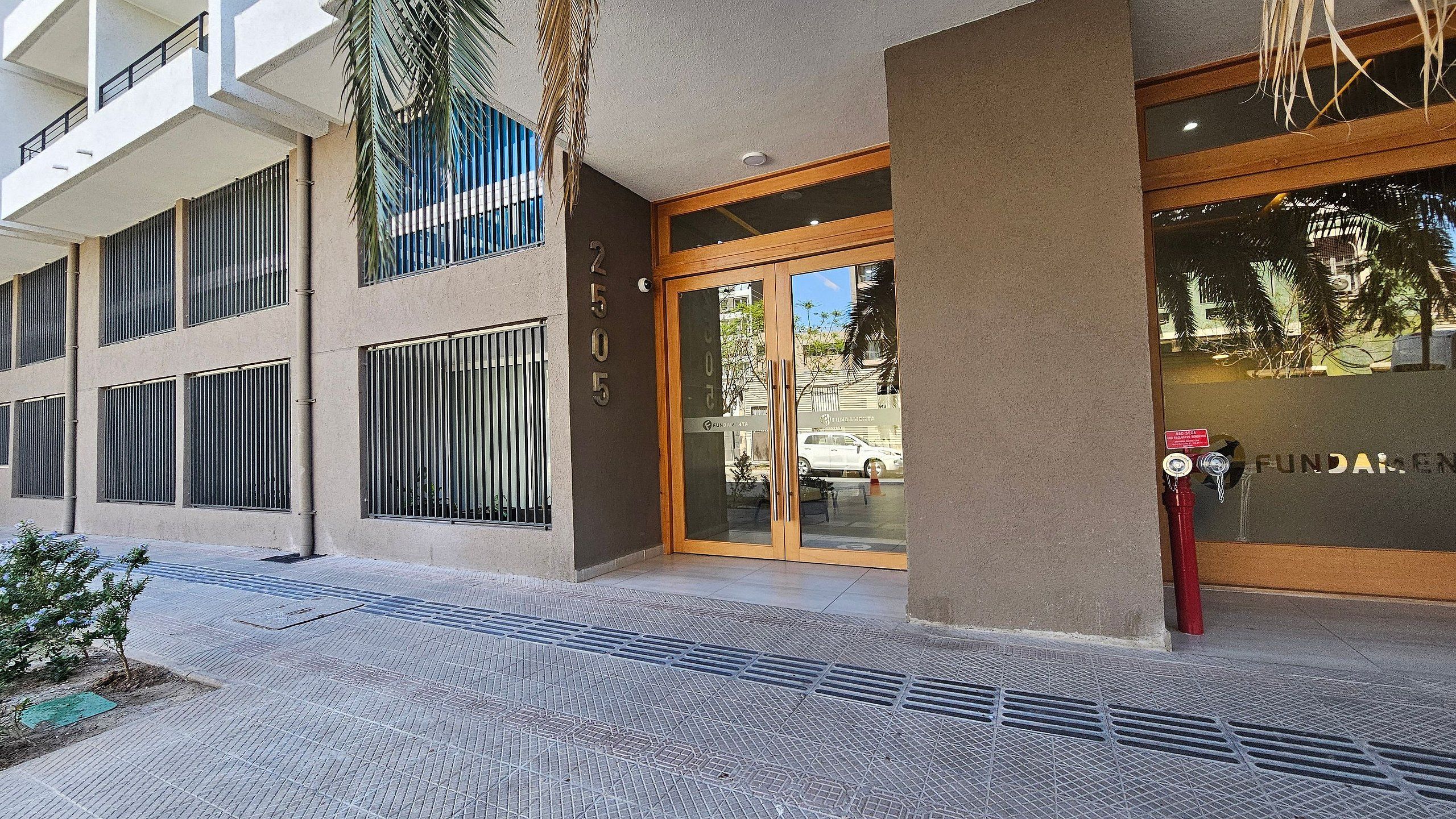 A building with a modern facade, large windows, and a visible entrance with glass doors.