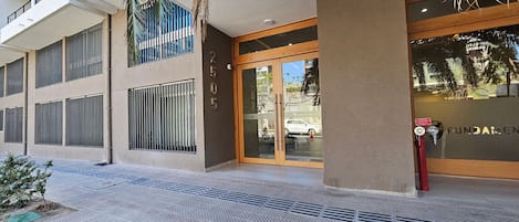 A building with a modern facade, large windows, and a visible entrance with glass doors.