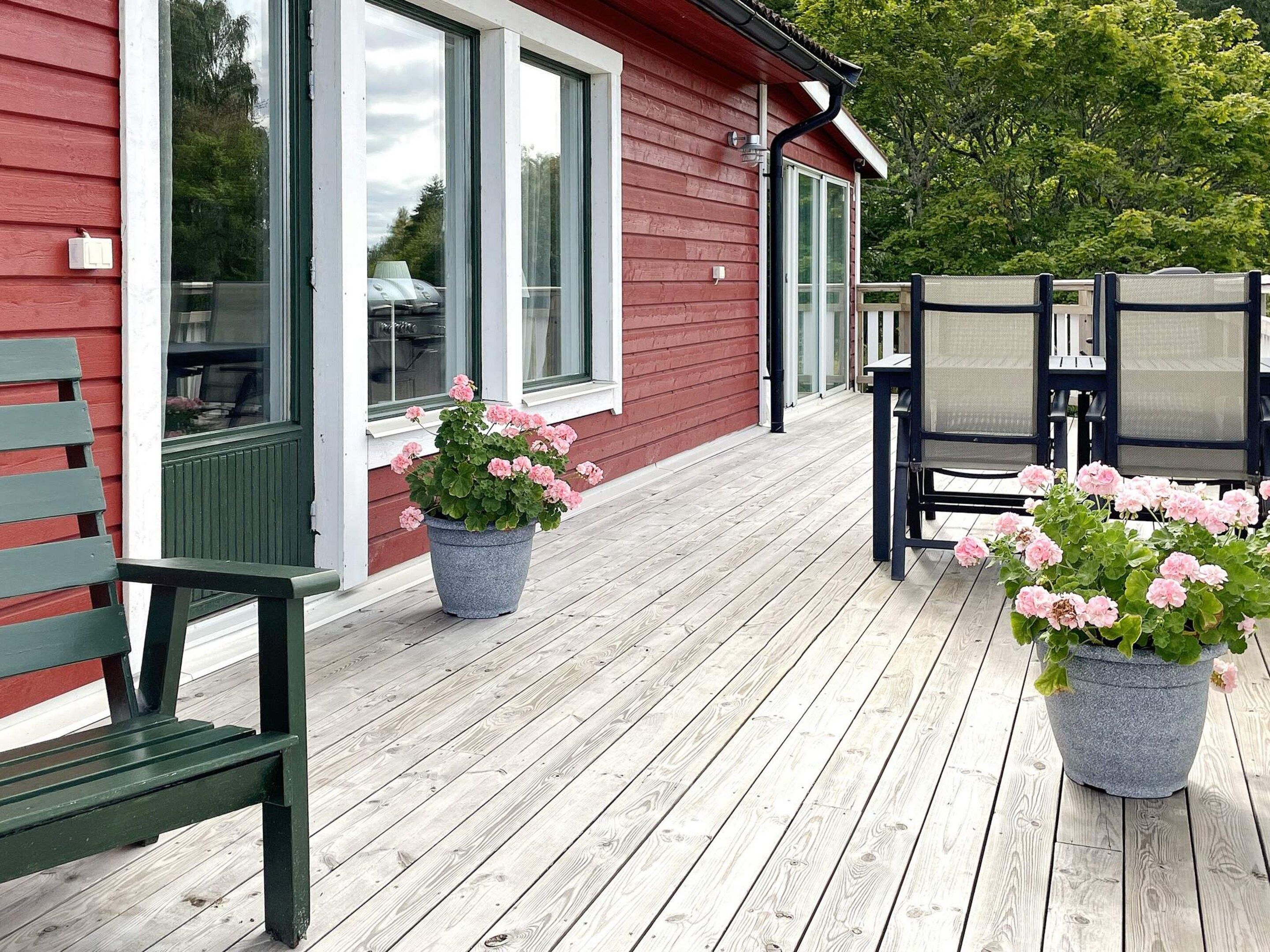 A wooden deck with outdoor seating and potted plants.