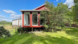 A red house with a small porch and a chimney. - 6 Person Holiday Home in Valdermarsvik (Gryt)