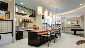 A modern kitchen with a central island, bar seating, and pendant lighting. - Landing | Stylish Studio, Pool, Gym (Dallas)