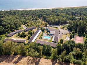 An aerial view of a resort with multiple buildings, a swimming pool, and a beach in the background. - 2 Person Holiday Home in Nexo (Nexø)