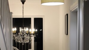A staircase with a chandelier and a pendant light. - Bramblemead 5 bed House in Manchester Leigh (Leigh)