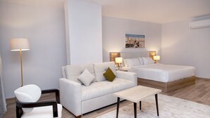 A modern hotel room with a sofa, a bed, a small table, and a chair. - AL Farida Boutique Pyramids (Giza)