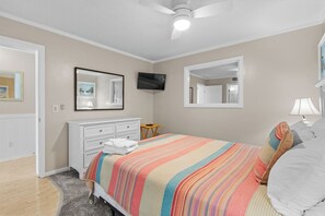 A bedroom with a bed, a dresser, a TV, and a ceiling fan. - A311 at the Myrtle Beach Resort (Myrtle Beach)