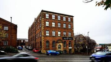 A brick building with a sign reading "Hall of Stiller."