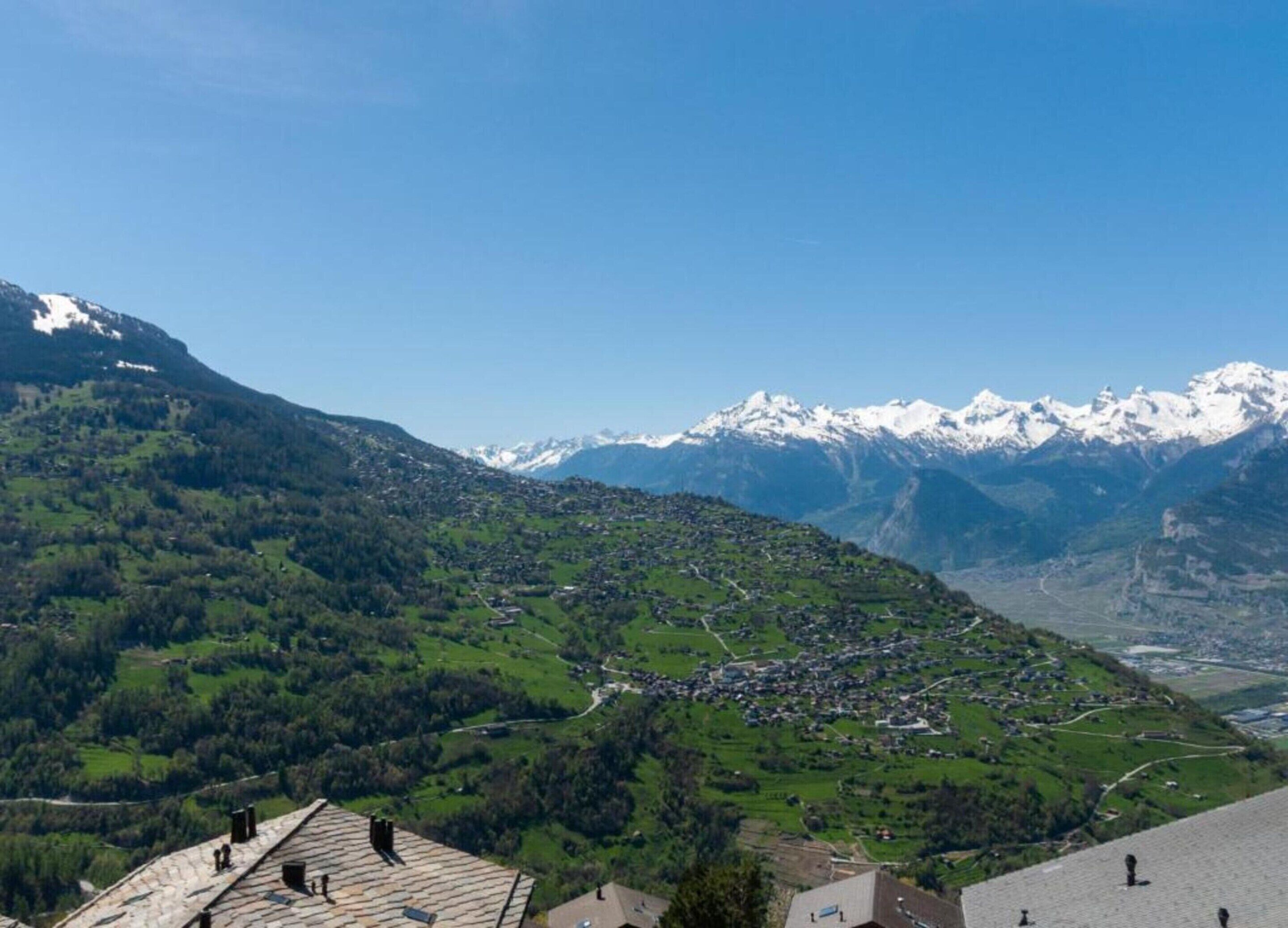 A mountainous landscape with a village nestled in the valley.