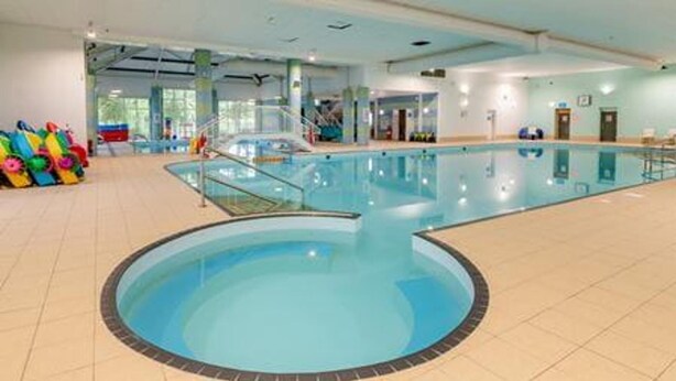 An indoor swimming pool with a clear water area, a diving board, and colorful pool toys. - 2 Bed Lodge Sleeps 5 - Pet Friendly, Wifi, Parking (Skegness)