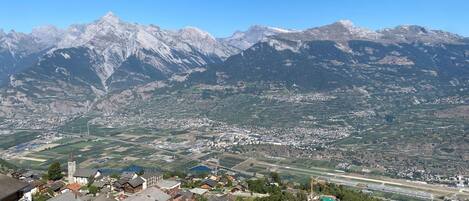 A mountainous landscape with a town nestled in the valley.