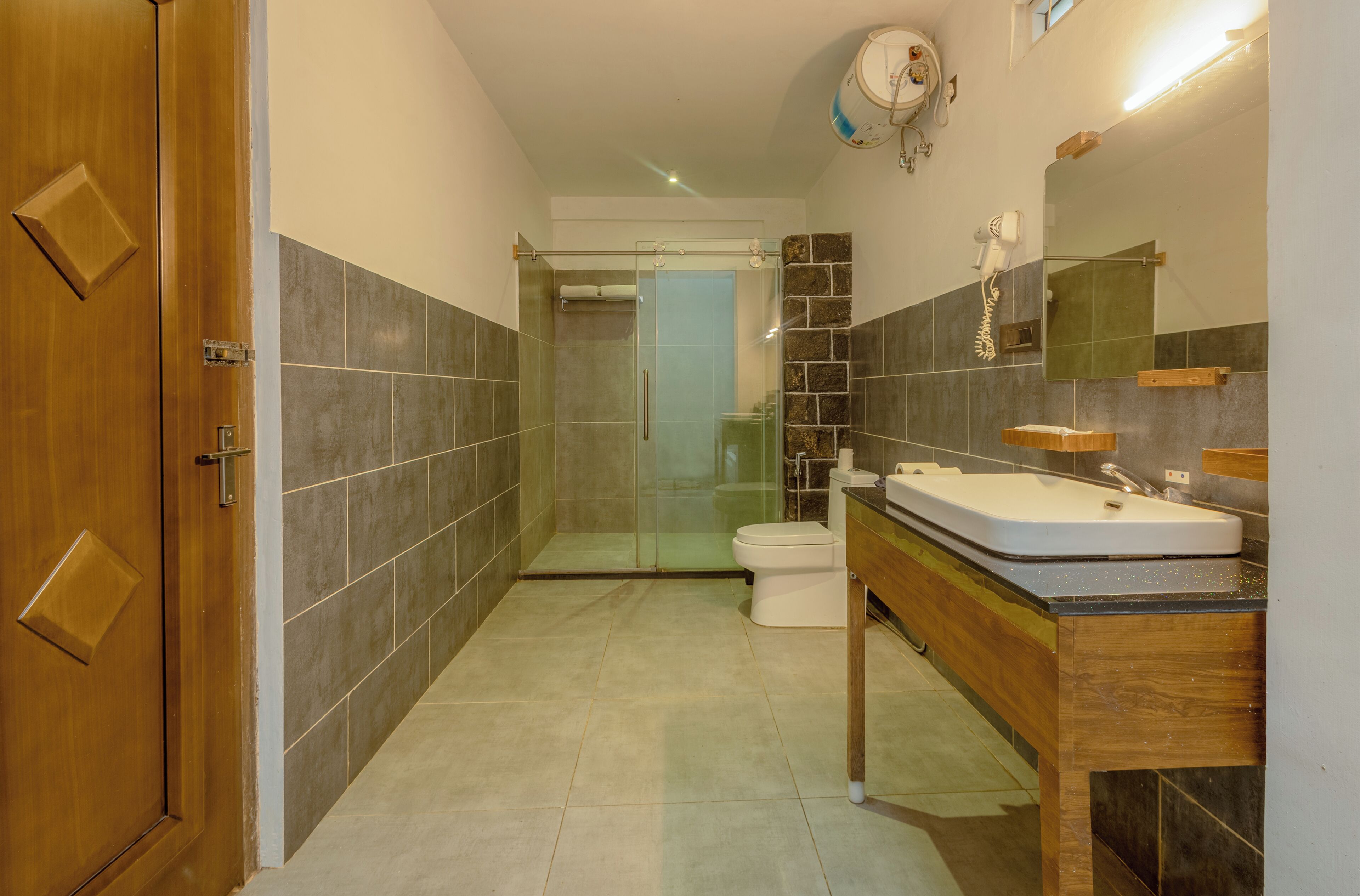A bathroom with a shower, toilet, and sink.
