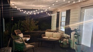 An outdoor deck with a sofa, chairs, and potted plants. - MARGARET'S PLACE ON SUNNYSIDE. A charming home for countryside relaxation (Greeneville)
