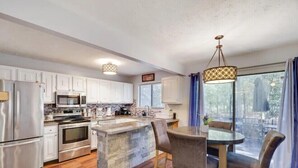 A modern kitchen with white cabinets, stainless steel appliances, and a central island. - Fantastic 3-bedroom house in Tobyhanna close to all major attractions. (Tobyhanna)