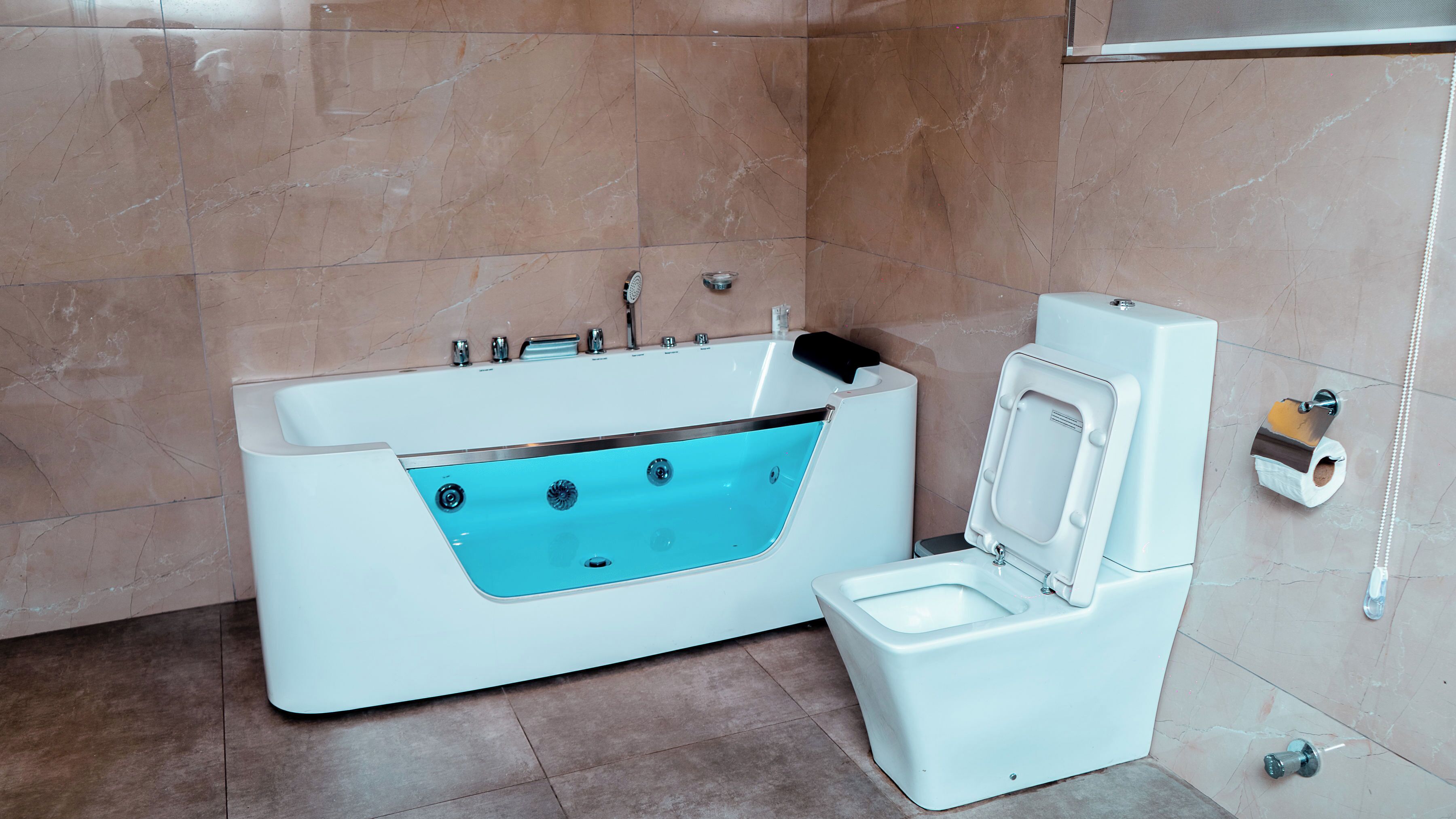 A bathroom with a bathtub, toilet, and a towel rack.