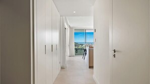 A modern hallway with white walls and a view of a balcony with a cityscape. - Hillside Flat With Pool in Palo Alto - Ref M49 (Ojén)