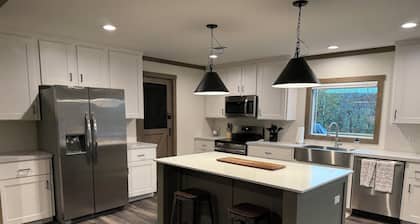 Lake front 4-bedroom house with fire pit and backyard path to the lake.