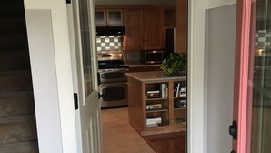 A kitchen with wooden cabinets, a microwave, and a stove.