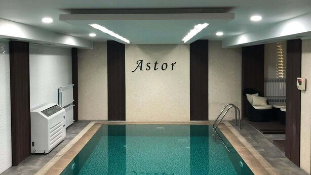 An indoor swimming pool with a wall labeled "Astor". - Astor (Bishkek)