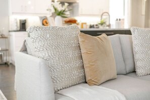 A sofa with textured pillows in a modern living room.