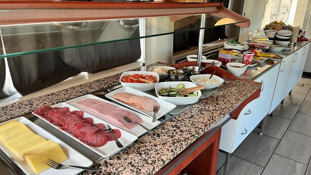 A buffet with various food items including meats, cheeses, and vegetables. - Hostel Oslofjord (Bærum)