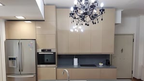 A modern kitchen with a stainless steel refrigerator, oven, and sink. - Luxury Living Athens  (Athens)