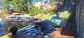 A deck with outdoor furniture, a small table, and a potted plant.