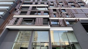 A modern building with multiple balconies, large windows, and a flat facade. - ON Augusta (São Paulo)