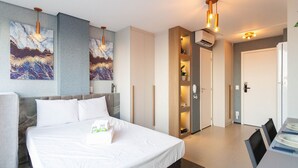 A modern hotel room with a large bed, a built-in wardrobe, and a small kitchenette. - ON Augusta (São Paulo)