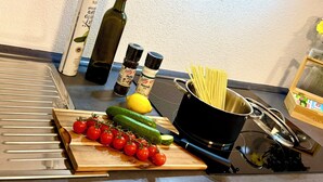 A kitchen counter with cooking ingredients and utensils.