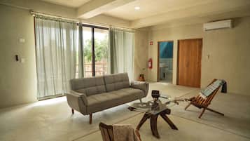 Family Suite, 4 Bedrooms, Patio, Courtyard View | Living area | Flat-screen TV
