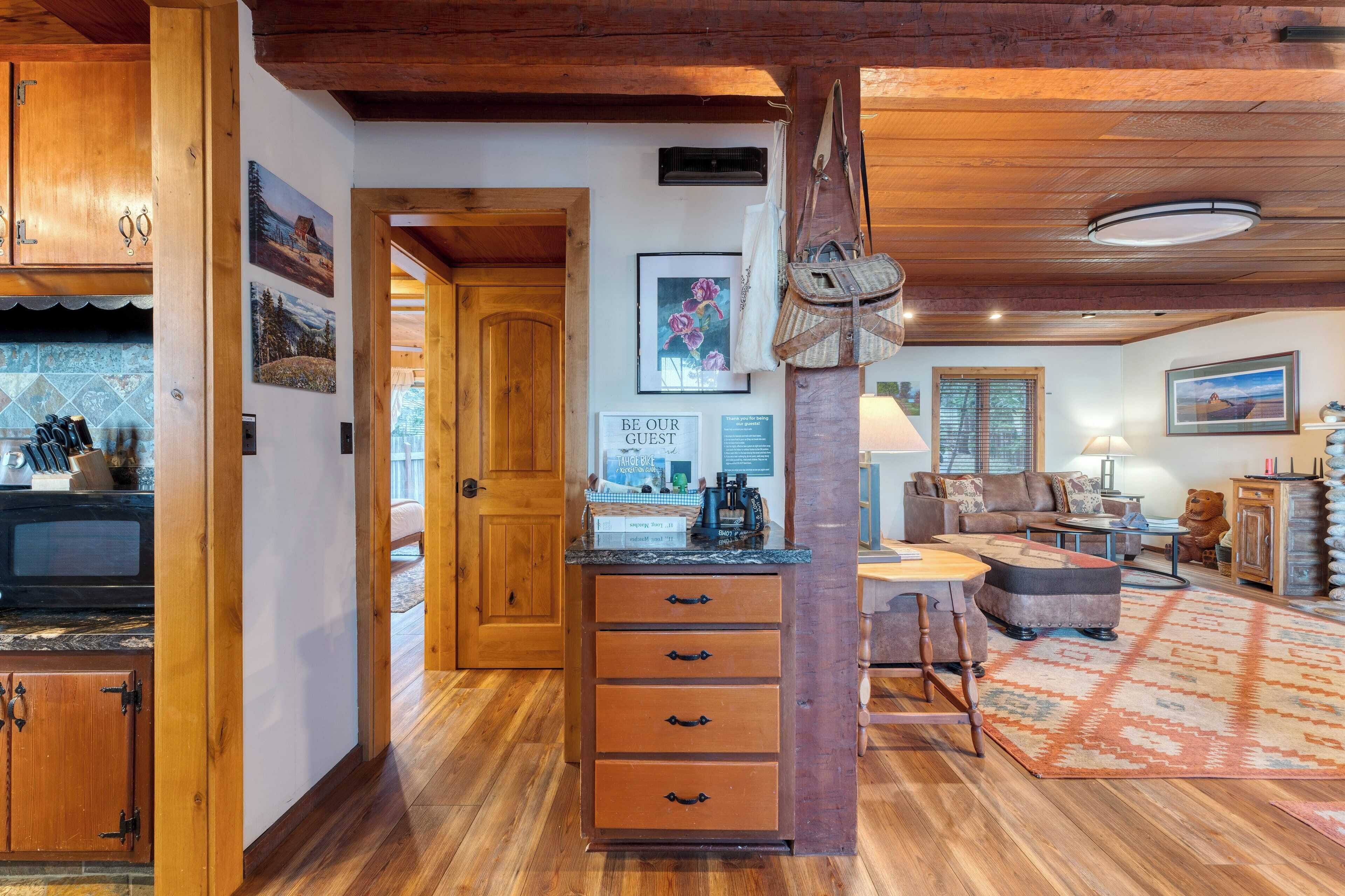 A wooden interior with a kitchen area, a dining space, and a living room.
