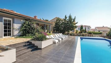 Seasonal outdoor pool, pool loungers
