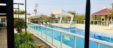 Deluxe Apartment, Patio, Beach View | Pool | 2 outdoor pools, pool umbrellas, sun loungers