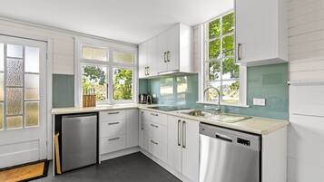 Fridge, stovetop, dishwasher, coffee/tea maker