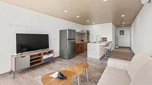 A modern apartment with a living room, kitchen, and dining area. - Apartment #3 -1-bedroom apartment with WiFi, AC in tranquil Tarcoles (Tarcoles)