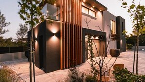 A modern two-story house with a flat roof, large windows, and a wooden slatted wall design. - Four Bedroom Villa with pool (Vodice)