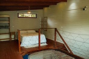 A rustic room with a wooden bed, a window, and a wooden ladder. - Surfway Ilha do Mel (Paranaguá)