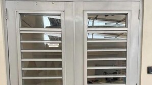 A double door with horizontal slats, a handle, and a keyhole. - Old San Juan Guesthouse.Free Parking, Rooftop & Generator – Casa Terra Porto #8 (San Juan)