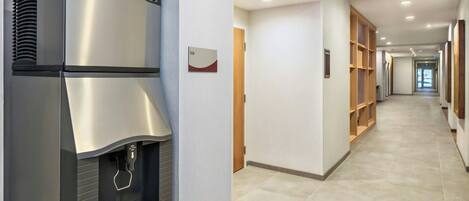 A modern kitchen with a stainless steel refrigerator and a built-in ice dispenser.