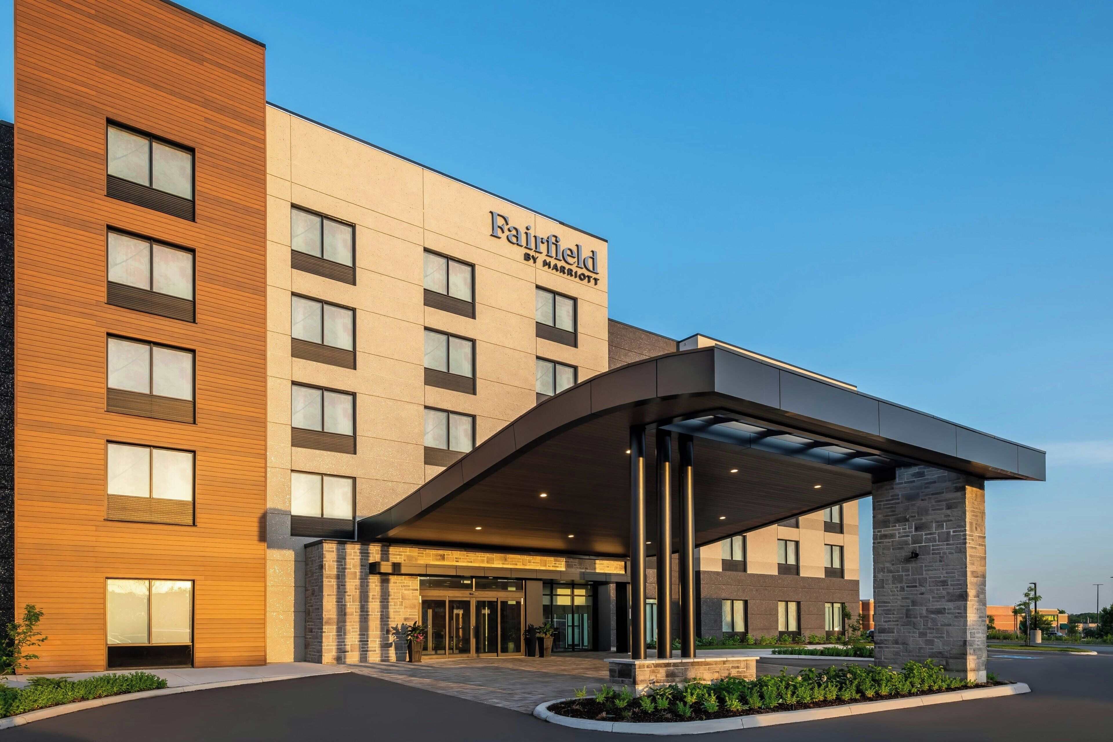 Un hôtel Fairfield by Marriott doté d’une façade moderne, d’une entrée couverte et d’un espace paysager à l’avant.