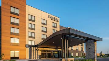 A Fairfield by Marriott hotel with a modern facade, a covered entrance, and a landscaped area in front.