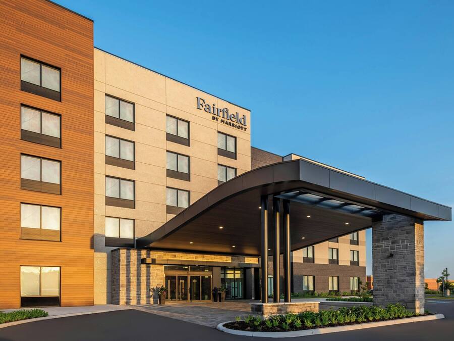 A Fairfield by Marriott hotel with a modern facade, a covered entrance, and a landscaped area in front.