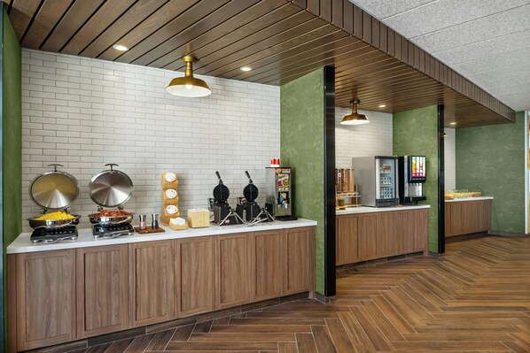A modern kitchen area with a buffet setup, including various food stations and appliances. - Fairfield Inn & Suites Gravenhurst Muskoka (Gravenhurst)