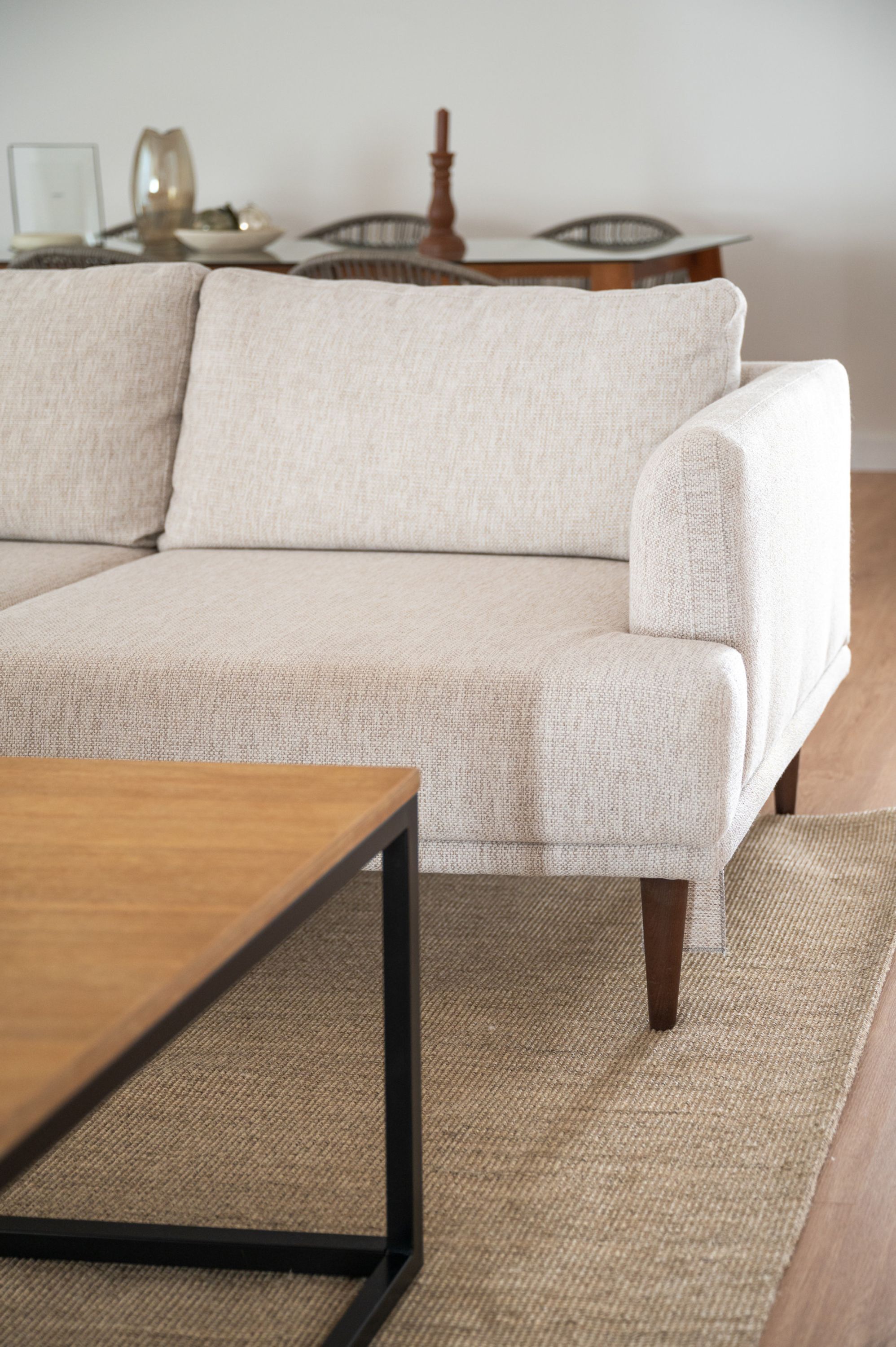 A sectional sofa with a wooden coffee table in front.