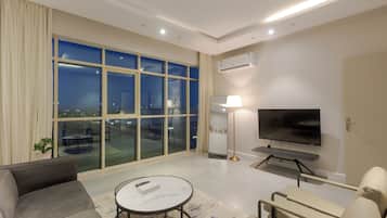 Luxury Apartment, City View | Living area | 55-inch Smart TV with digital channels, printers