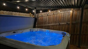 Private covered hot tub with ambient lighting and spa-like vibes